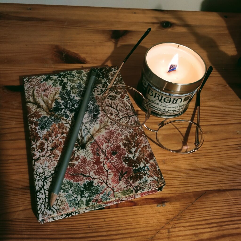 Candle, glasses and notebook